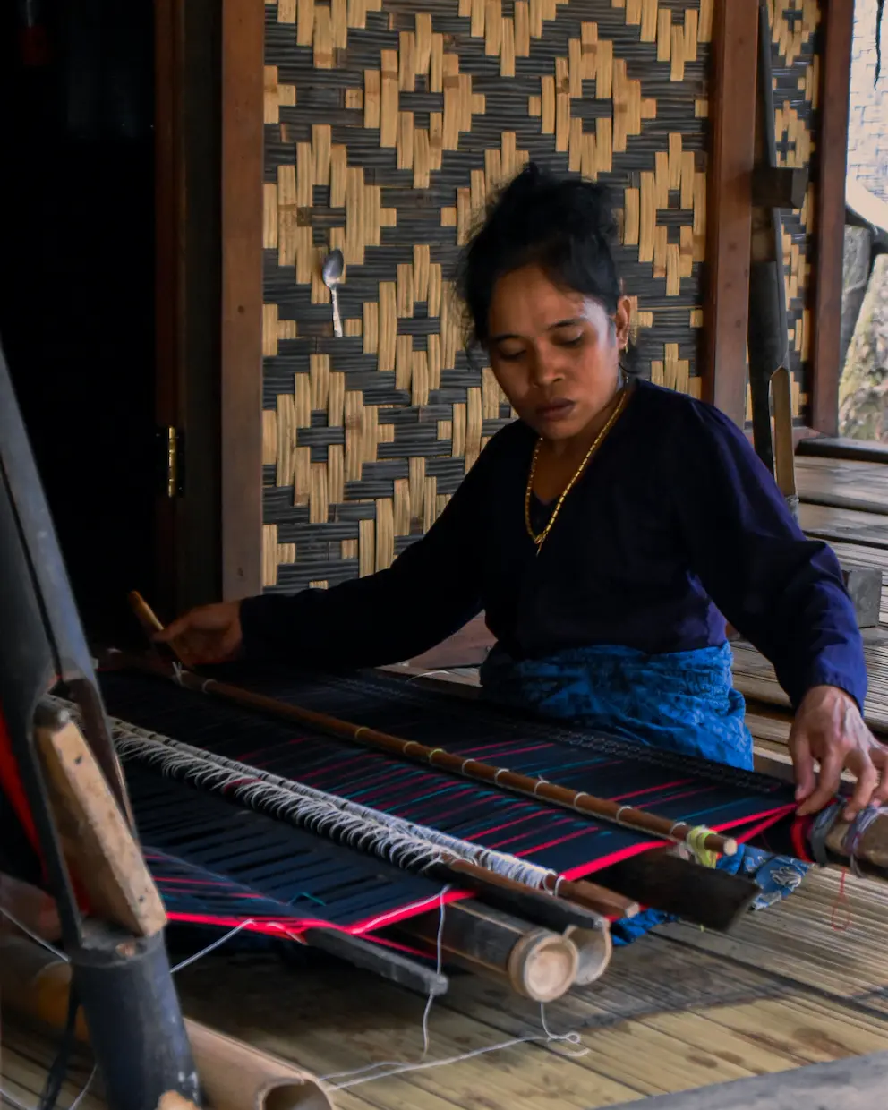 Traditional Balinese weaver using a bamboo loom